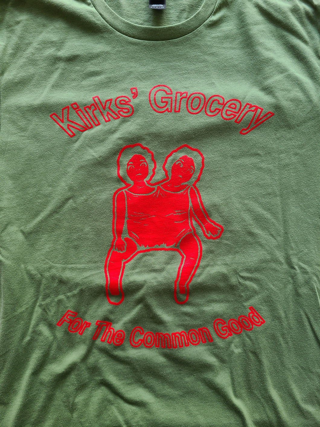 Kirks' Grocery Unisex T-Shirt | Two Headed Doll (Red on Green)